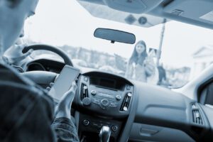 Distracted driver risks hitting a pedestrian