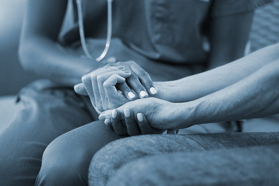 Friend holds hands of victim after wrongful death