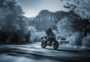 Motorcyclists parks his bike in the shadow of Zion Canyon's red rocks