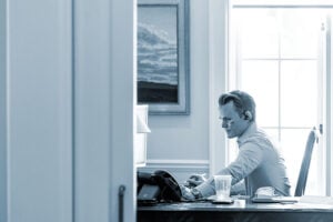 Attorney takes a phone on a headset in his office