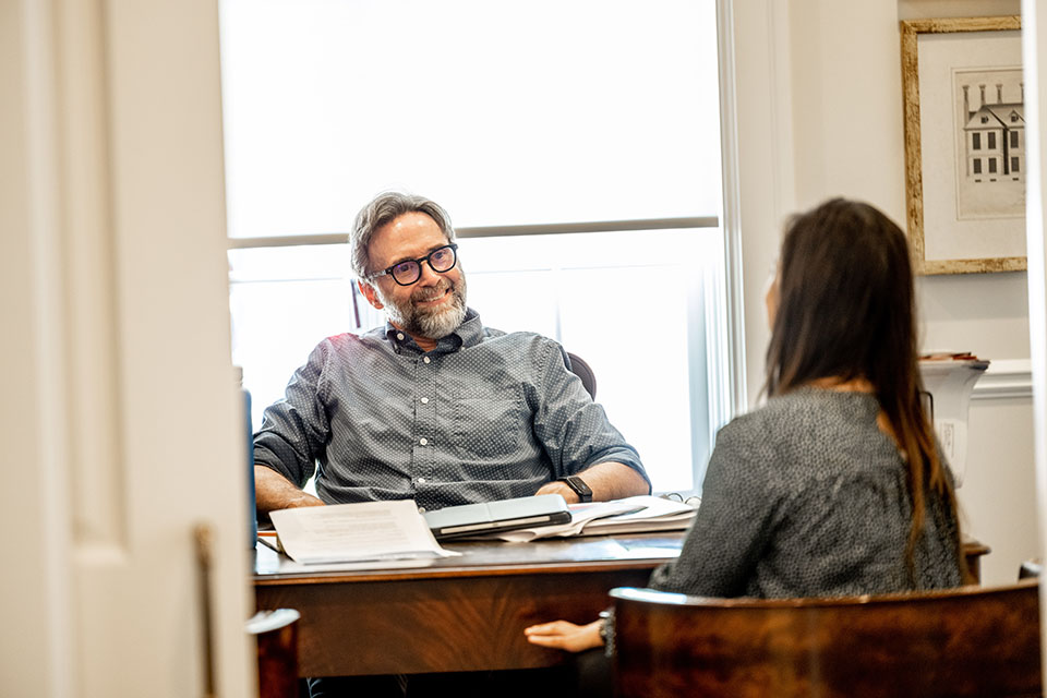 Attorney talks with a client in his office