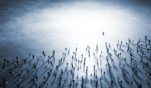 People walk from darkness into light