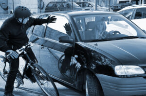 Cyclist gets hit by the side of the car.