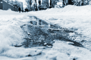 Frozen sidewalk covering in snow